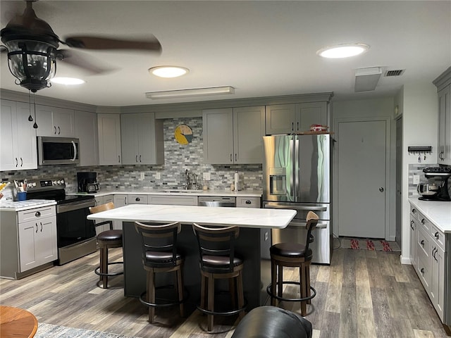 8533 SW 93rd Pl Unit A, Ocala, FL 34481 - kitchen featuring appliances with stainless steel finishes, tasteful backsplash, and a kitchen breakfast bar