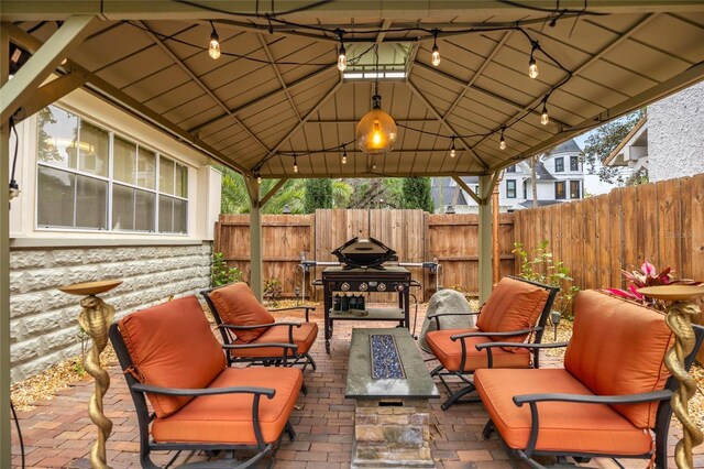 44 SE 9th Ter, Ocala, FL 34471 - view of patio featuring an outdoor living space with a fire pit, fence, a gazebo, and grilling area