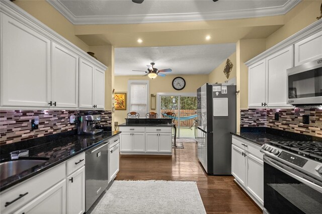 44 SE 9th Ter, Ocala, FL 34471 - kitchen with white cabinetry, ornamental molding, dark wood-type flooring, and stainless steel appliances