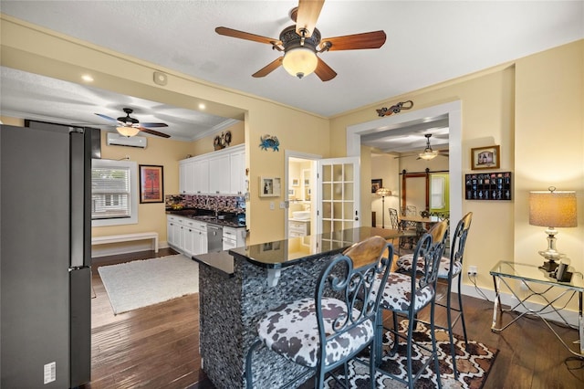 44 SE 9th Ter, Ocala, FL 34471 - kitchen with white cabinetry, ceiling fan, stainless steel appliances, and dark countertops