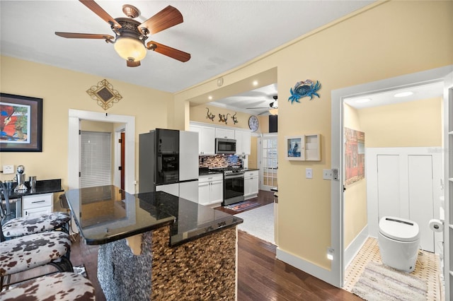 44 SE 9th Ter, Ocala, FL 34471 - kitchen featuring white cabinets, a ceiling fan, stainless steel appliances, and dark wood-style floors