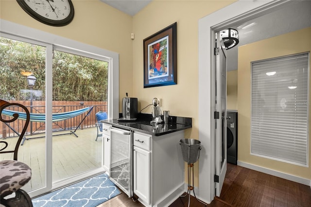 44 SE 9th Ter, Ocala, FL 34471 - kitchen with dark wood finished floors, beverage cooler, baseboards, dark countertops, and white cabinets