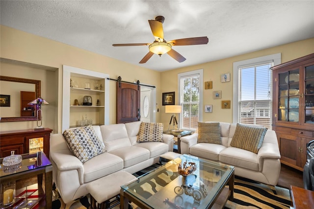 44 SE 9th Ter, Ocala, FL 34471 - living area featuring a barn door, ceiling fan, and a textured ceiling