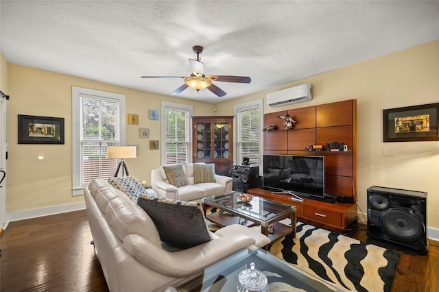 44 SE 9th Ter, Ocala, FL 34471 - living area with a wall unit AC, dark wood-type flooring, baseboards, a textured ceiling, and ceiling fan