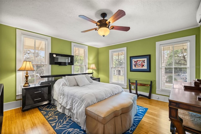 44 SE 9th Ter, Ocala, FL 34471 - bedroom with crown molding, wood finished floors, a textured ceiling, baseboards, and ceiling fan