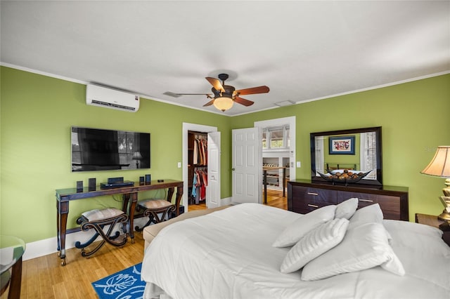 44 SE 9th Ter, Ocala, FL 34471 - bedroom with crown molding, a ceiling fan, wood finished floors, a wall mounted air conditioner, and baseboards