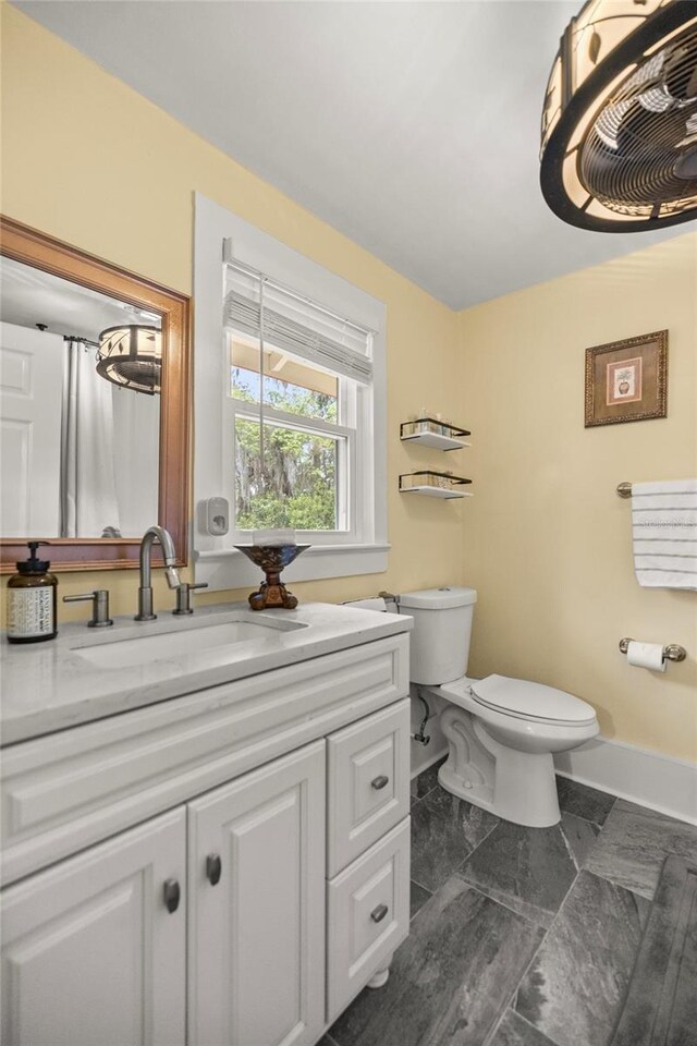 44 SE 9th Ter, Ocala, FL 34471 - bathroom featuring toilet, vanity, and baseboards