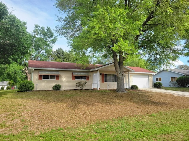 ranch-style home with a front yard, a garage, and concrete driveway