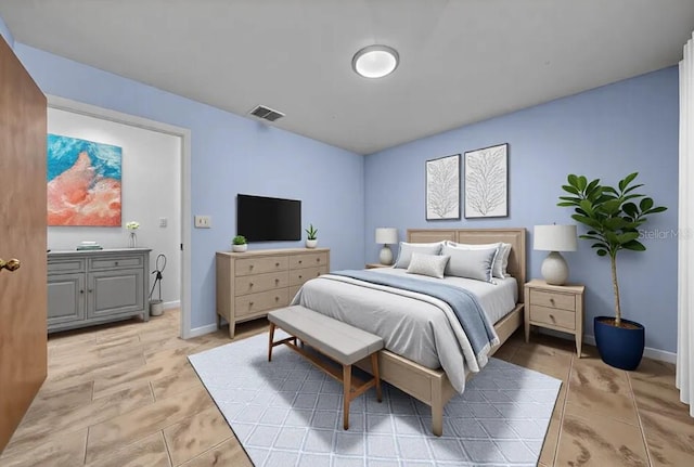 bedroom with baseboards and visible vents