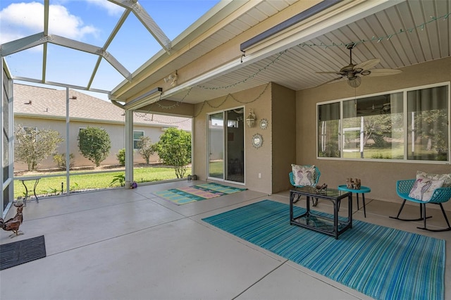 view of patio with a lanai, a ceiling fan, and visible vents