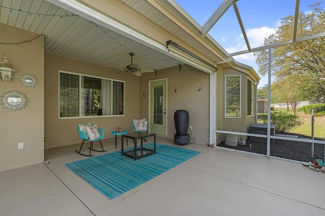 sunroom / solarium with a ceiling fan and a wealth of natural light