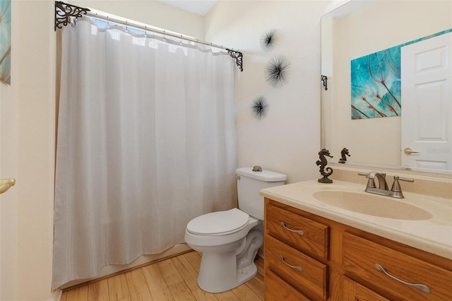 full bath featuring toilet, curtained shower, wood finished floors, and vanity