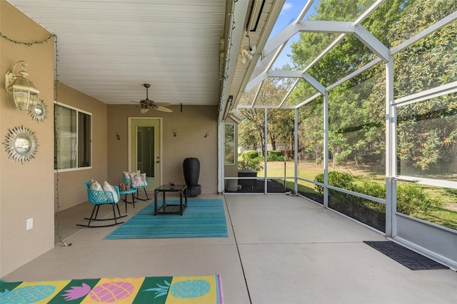 unfurnished sunroom featuring ceiling fan