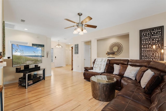 living area with visible vents, ceiling fan, and light wood-type flooring