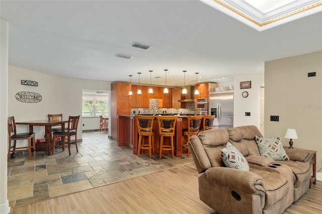 living area with bar, visible vents, and recessed lighting