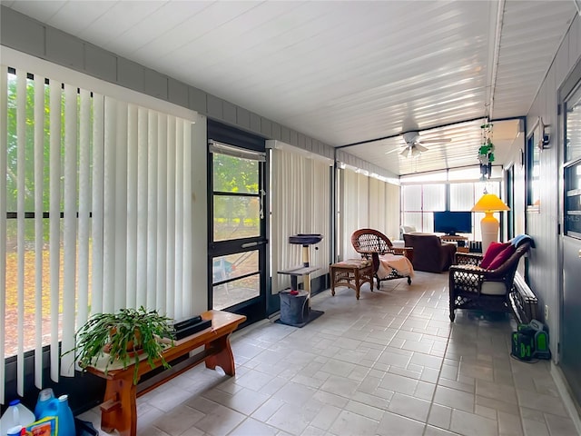 sunroom featuring a ceiling fan