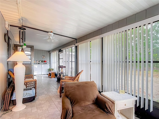 sunroom with stone finish floor and independent washer and dryer