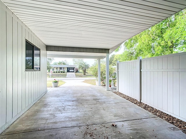 view of patio / terrace with a carport and fence
