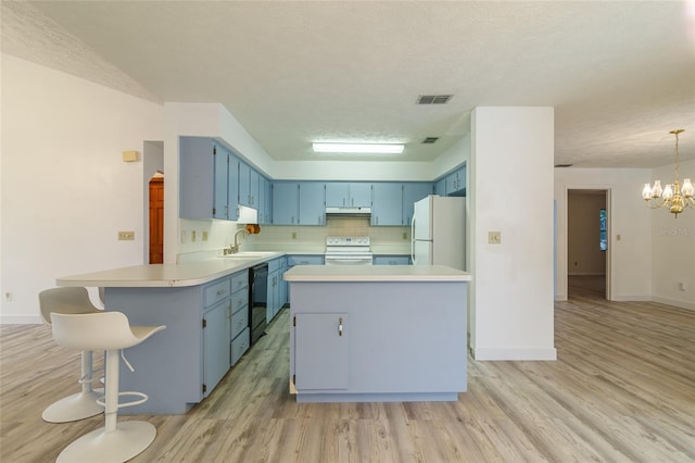kitchen with freestanding refrigerator, blue cabinets, a peninsula, black dishwasher, and electric stove