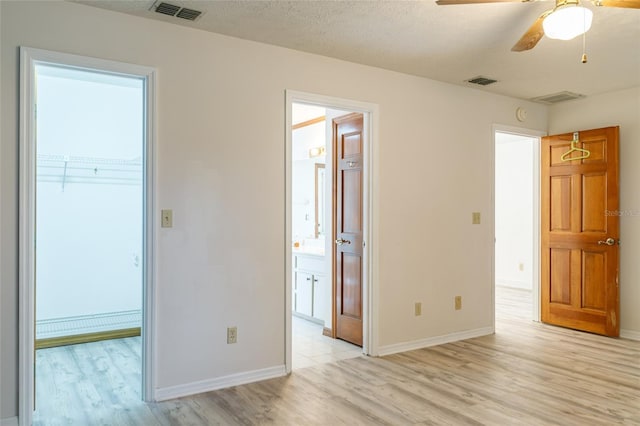 empty room featuring visible vents and light wood-style floors