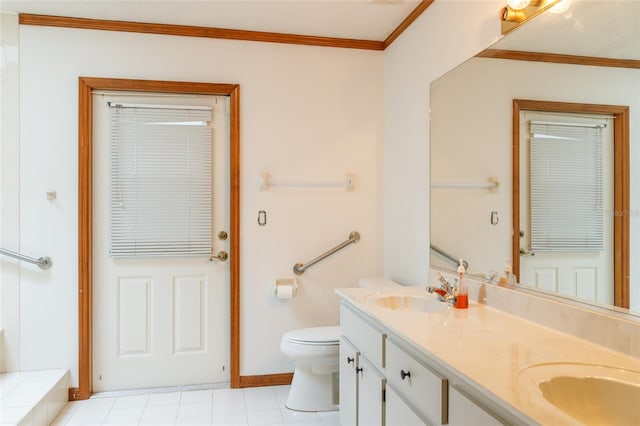 bathroom with double vanity, toilet, ornamental molding, and a sink