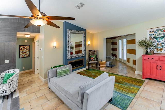 5770 SW 89th Pl, Ocala, FL 34476 - living room with vaulted ceiling, visible vents, a ceiling fan, light tile patterned floors, and baseboards