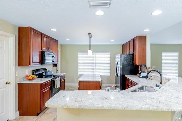 5770 SW 89th Pl, Ocala, FL 34476 - kitchen with a peninsula, a sink, visible vents, a kitchen island, and black appliances