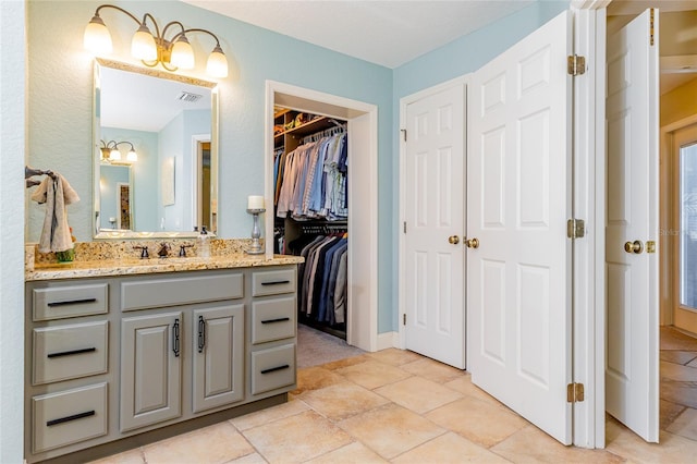 5770 SW 89th Pl, Ocala, FL 34476 - bathroom featuring a spacious closet, vanity, and visible vents