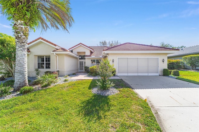 11427 SW 82nd Ave, Ocala, FL 34481 - view of front of house featuring an attached garage, a tile roof, stucco siding, a front lawn, and driveway