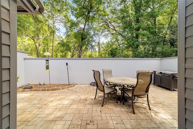view of patio / terrace featuring fence and outdoor dining space