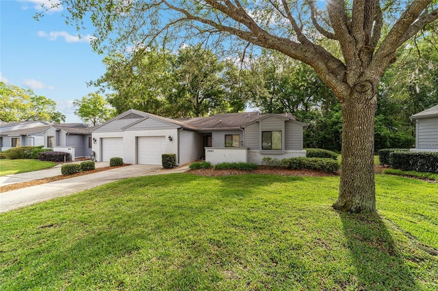 ranch-style house featuring a front yard, an attached garage, brick siding, and concrete driveway