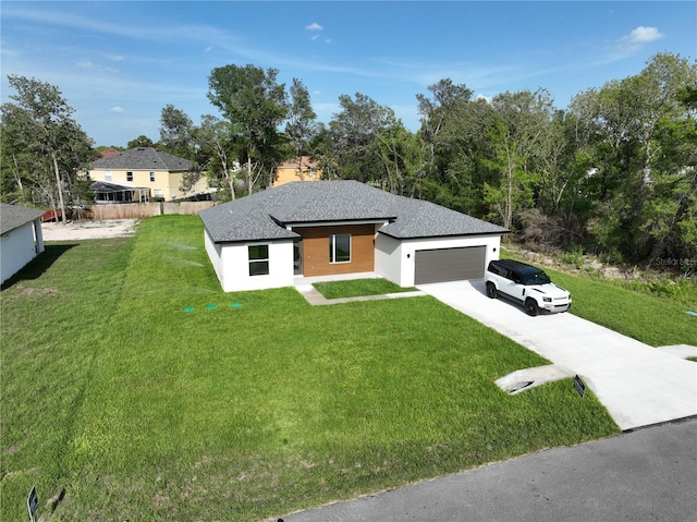 11555 SW 59th Ter, Ocala, FL 34476 - view of front facade featuring concrete driveway, a garage, and stucco siding