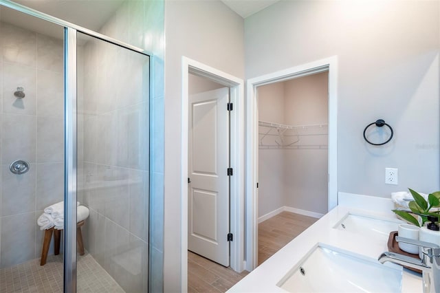 11555 SW 59th Ter, Ocala, FL 34476 - bathroom featuring a shower stall, a spacious closet, double vanity, and wood tiled floors