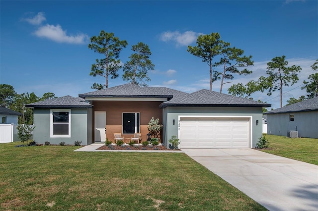 11555 SW 59th Ter, Ocala, FL 34476 - view of front facade featuring a garage, driveway, a front lawn, stucco siding, and roof with shingles