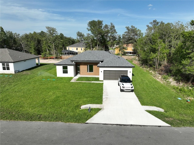 11555 SW 59th Ter, Ocala, FL 34476 - view of front of home featuring driveway, a front lawn, stucco siding, and an attached garage
