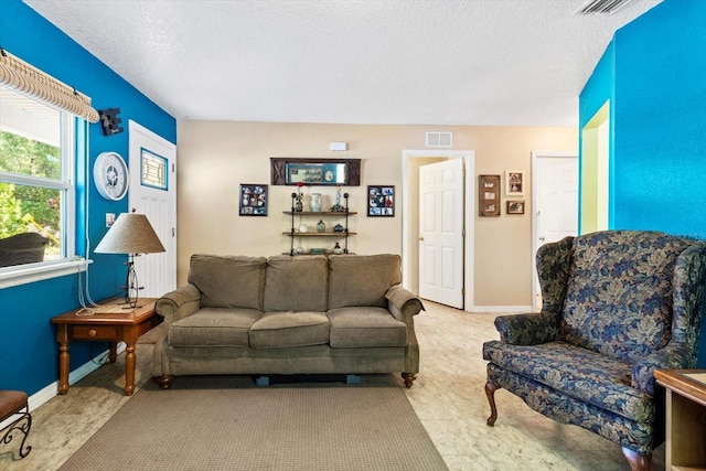 8570 N Discalfani Loop, Crystal River, FL 34428 - living room with baseboards, a textured ceiling, and visible vents