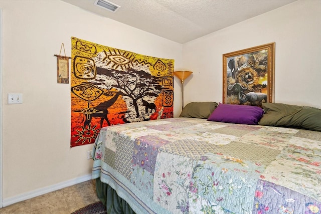 8570 N Discalfani Loop, Crystal River, FL 34428 - bedroom with a textured ceiling, baseboards, and visible vents