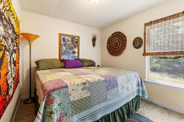 8570 N Discalfani Loop, Crystal River, FL 34428 - bedroom featuring baseboards and a textured ceiling