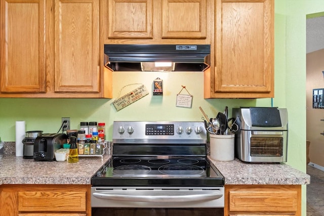 8570 N Discalfani Loop, Crystal River, FL 34428 - kitchen with light countertops, stainless steel range with electric cooktop, and extractor fan