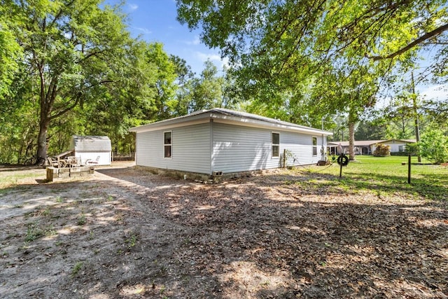 8570 N Discalfani Loop, Crystal River, FL 34428 - back of property featuring an outdoor structure and a storage shed