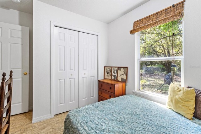 8570 N Discalfani Loop, Crystal River, FL 34428 - bedroom with multiple windows, a closet, and baseboards