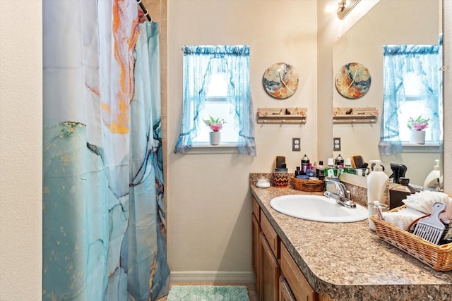 8570 N Discalfani Loop, Crystal River, FL 34428 - bathroom with a shower with curtain, vanity, baseboards, and a wealth of natural light