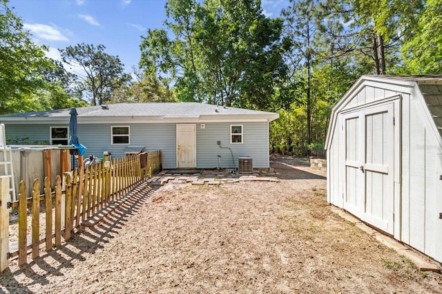 8570 N Discalfani Loop, Crystal River, FL 34428 - back of property featuring a shed, an outdoor structure, fence, and central AC