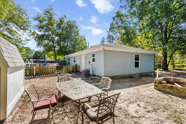 8570 N Discalfani Loop, Crystal River, FL 34428 - view of patio featuring a fire pit, central air condition unit, fence, and outdoor dining space