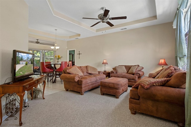 6 Statice Ct, Homosassa, FL 34446 - carpeted living area featuring a ceiling fan, a tray ceiling, visible vents, and tile patterned floors