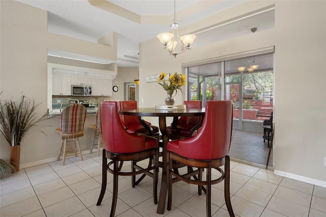 6 Statice Ct, Homosassa, FL 34446 - dining space featuring baseboards, light tile patterned flooring, a chandelier, and a raised ceiling