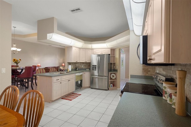 6 Statice Ct, Homosassa, FL 34446 - kitchen with a sink, a peninsula, tasteful backsplash, appliances with stainless steel finishes, and a notable chandelier