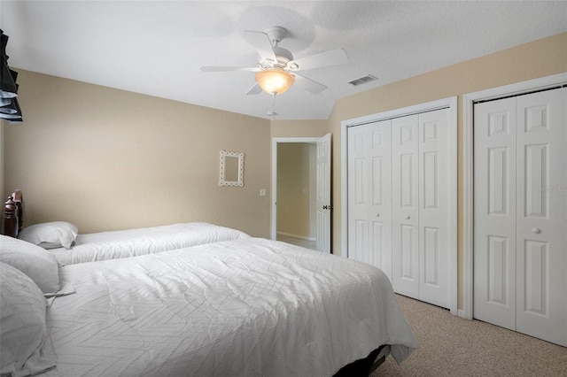 6 Statice Ct, Homosassa, FL 34446 - bedroom with light carpet, a ceiling fan, multiple closets, and visible vents