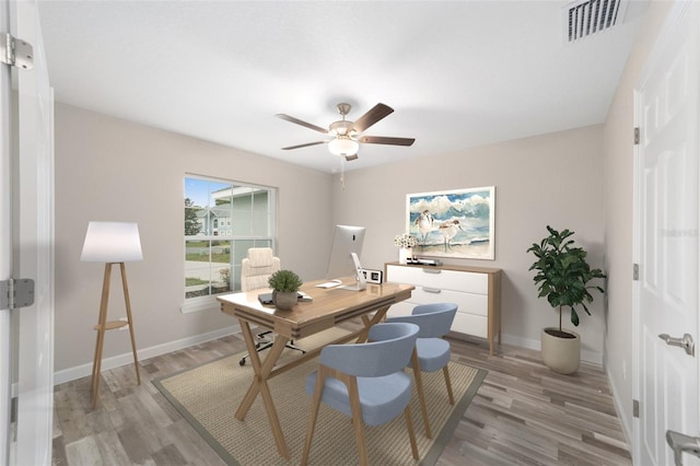 office with baseboards, light wood-style floors, ceiling fan, and visible vents