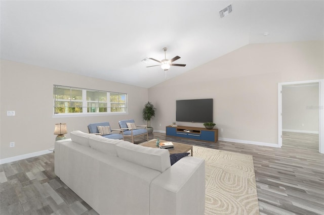 living area with a ceiling fan, wood finished floors, lofted ceiling, and visible vents